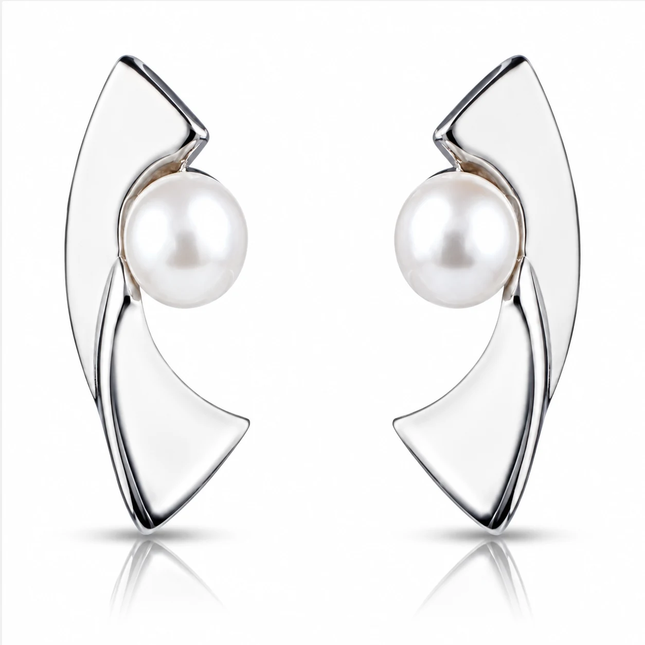 Pair of contemporary curved silver stud earrings with white freshwater cultured pearls, displayed close-up on a white background.
